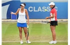 BIRMINGHAM, ENGLAND - JUNE 15:  Ashleigh Barty (R) and Casey Dellacqua of Australia confer during the Doubles Final during Day Seven of the Aegon Classic at Edgbaston Priory Club on June 15, 2014 in Birmingham, England.  (Photo by Tom Dulat/Getty Images)